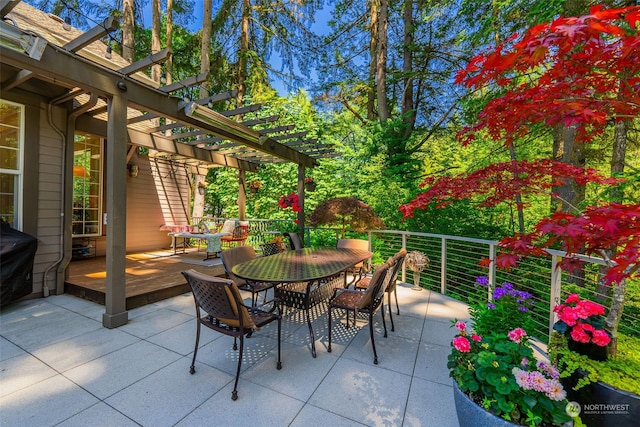 view of patio / terrace with a wooden deck, a pergola, and outdoor dining space