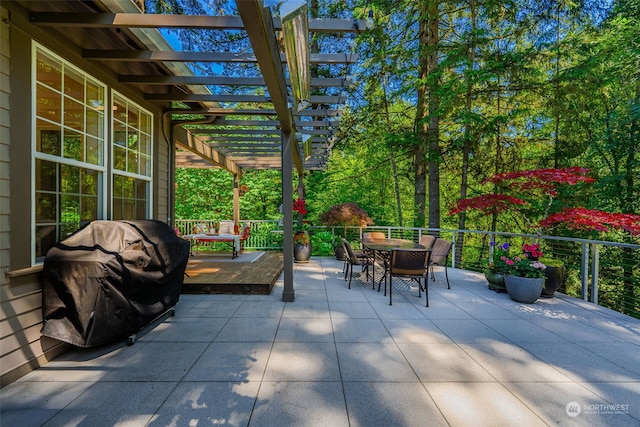 view of patio / terrace with a grill, outdoor dining area, a pergola, and a wooden deck