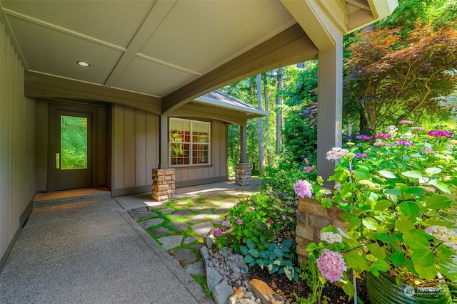 view of exterior entry featuring board and batten siding