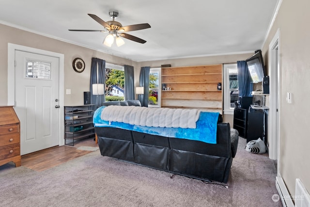 bedroom with ornamental molding, a baseboard heating unit, wood-type flooring, and ceiling fan