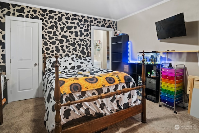 carpeted bedroom featuring crown molding and ensuite bath