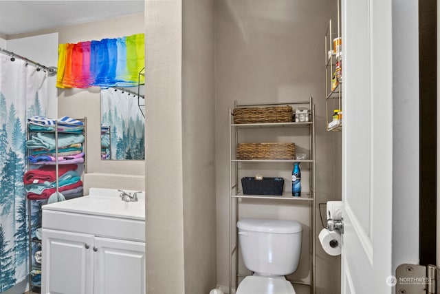 bathroom featuring vanity and toilet