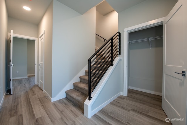 stairway with hardwood / wood-style floors