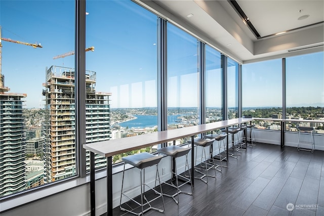 sunroom featuring a water view