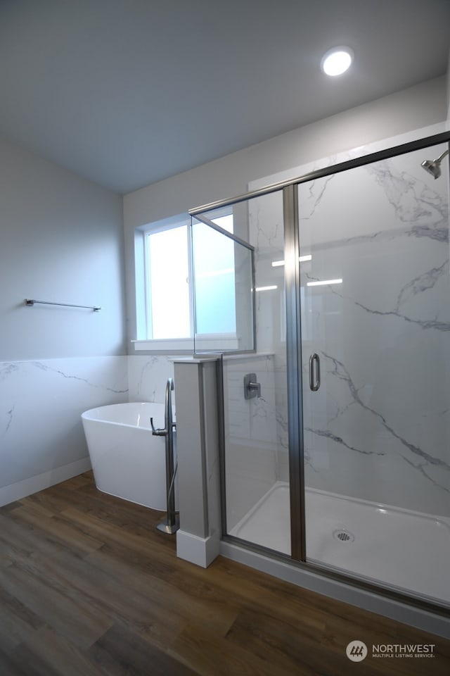 bathroom featuring a shower with shower door and hardwood / wood-style floors