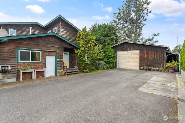 view of front facade with an outbuilding and a garage