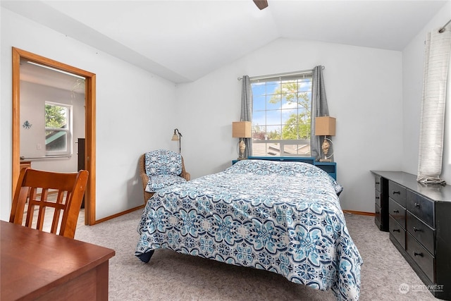 carpeted bedroom featuring multiple windows, vaulted ceiling, and ceiling fan