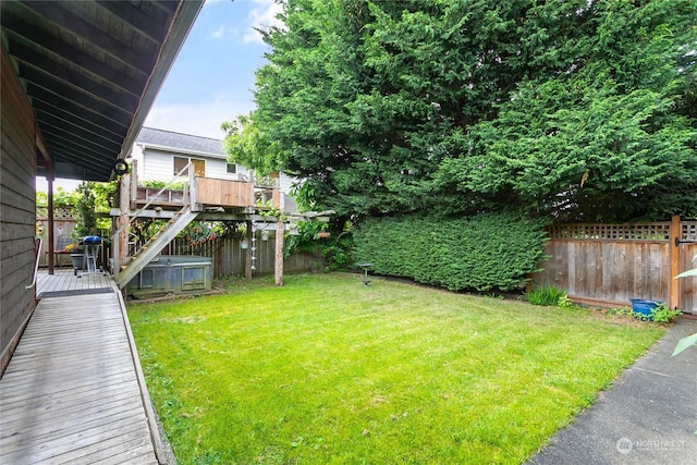 view of yard featuring a deck and central air condition unit