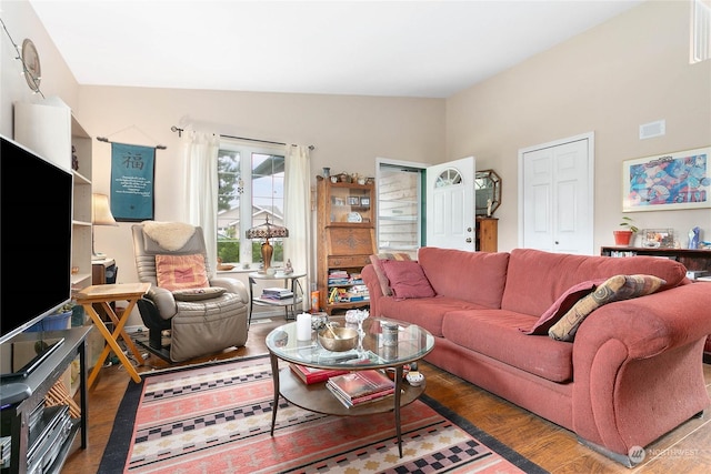 living room with dark wood-type flooring and lofted ceiling