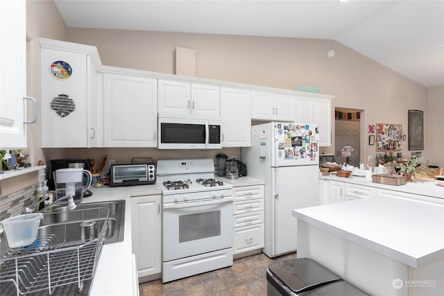 kitchen with white cabinetry, white appliances, and vaulted ceiling