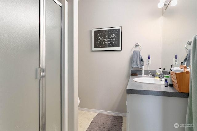 bathroom with vanity and a shower with shower door