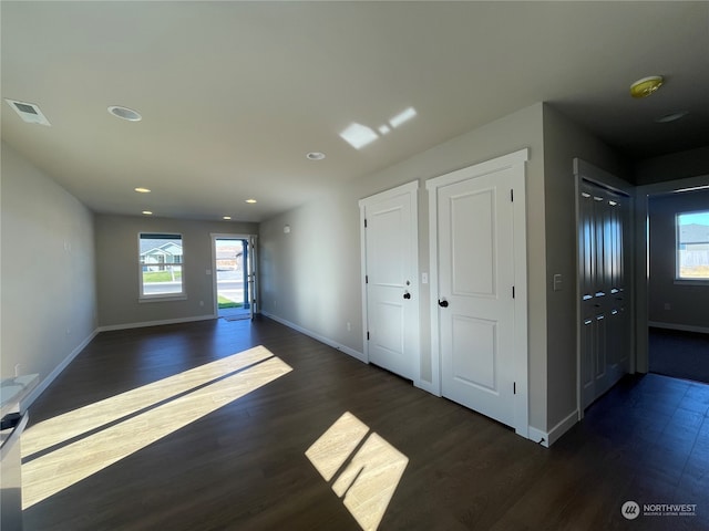 spare room featuring dark wood-type flooring