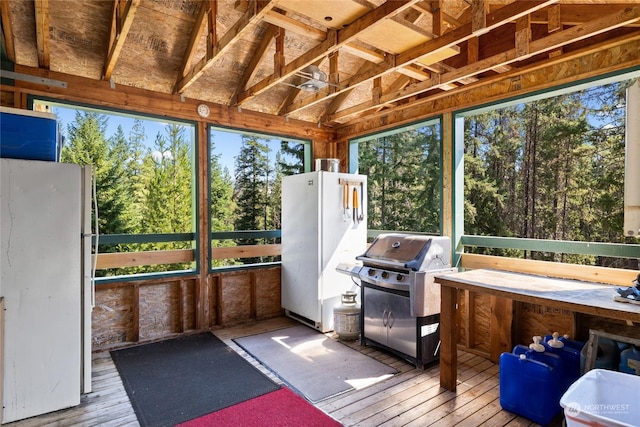 sunroom / solarium featuring lofted ceiling