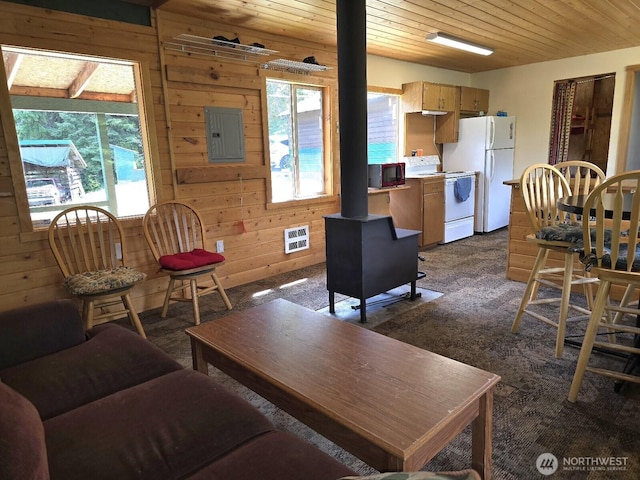 291 Spoke Ln, Cle Elum, WA 98922 - living area with healthy amount of natural light, electric panel, dark carpet, wooden ceiling, and wood walls