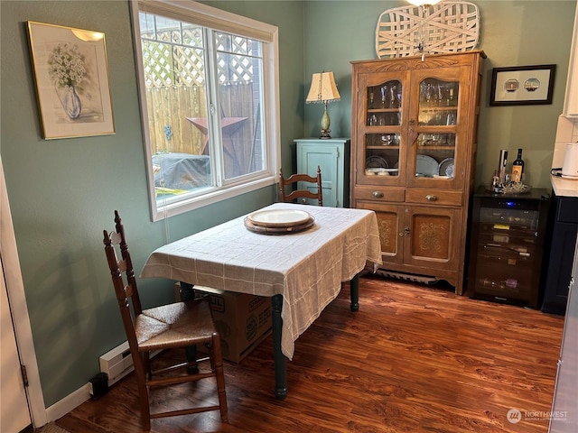 dining room featuring wine cooler and dark hardwood / wood-style floors