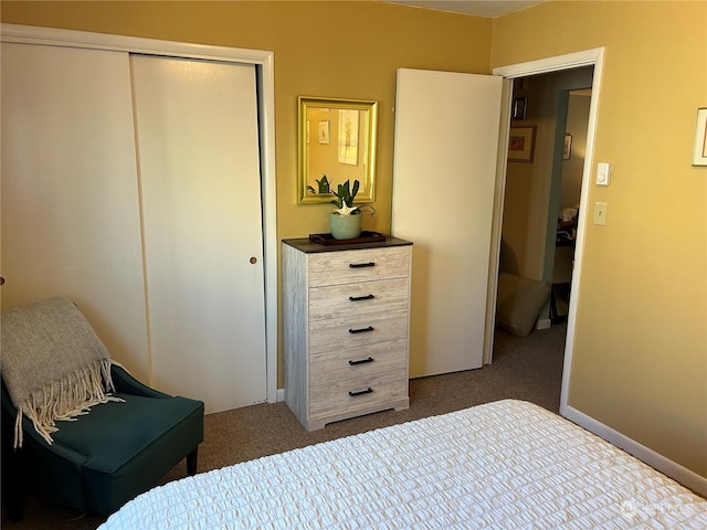 bedroom featuring a closet and dark colored carpet