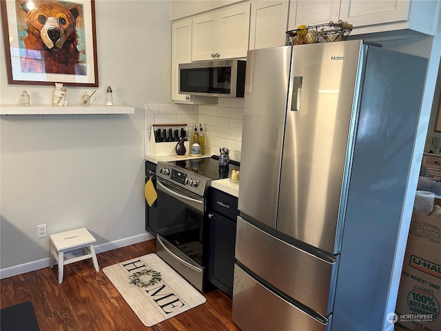 kitchen featuring decorative backsplash, dark wood-type flooring, white cabinets, and appliances with stainless steel finishes