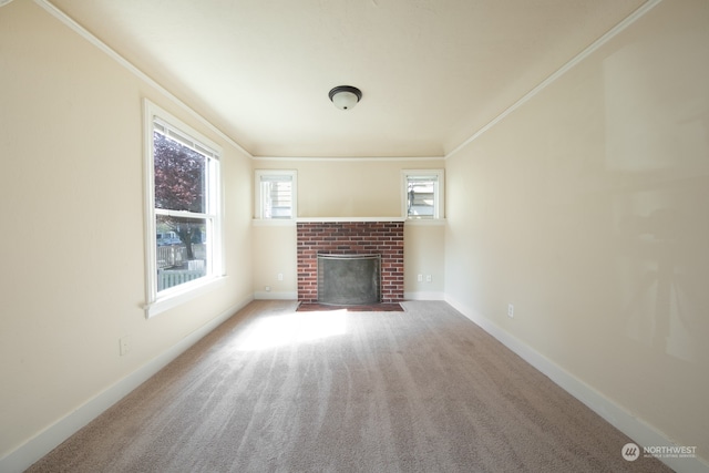 unfurnished living room with ornamental molding, a brick fireplace, and carpet flooring