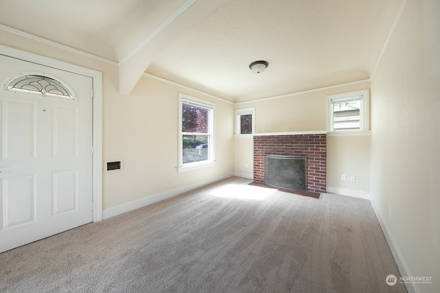 unfurnished living room featuring a fireplace, carpet flooring, and a wealth of natural light