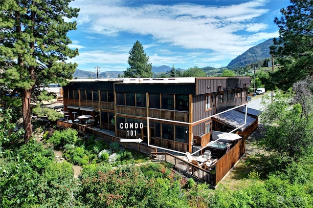 rear view of house featuring a mountain view