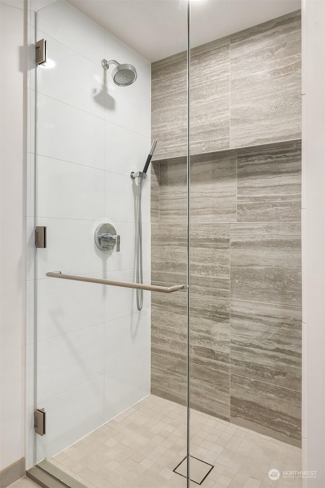 bathroom featuring a shower with shower door