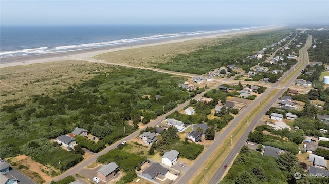 aerial view with a water view and a beach view