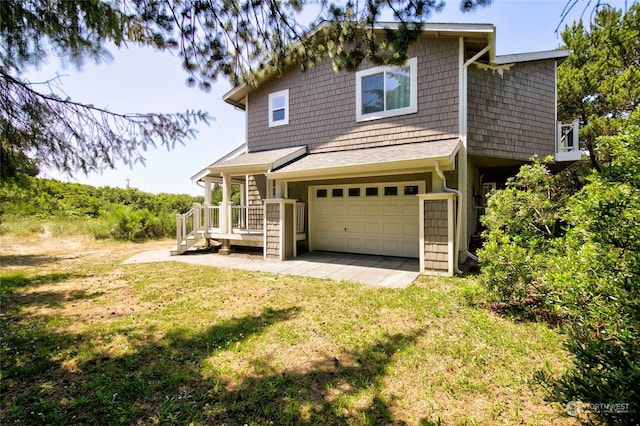 exterior space featuring a garage and a lawn