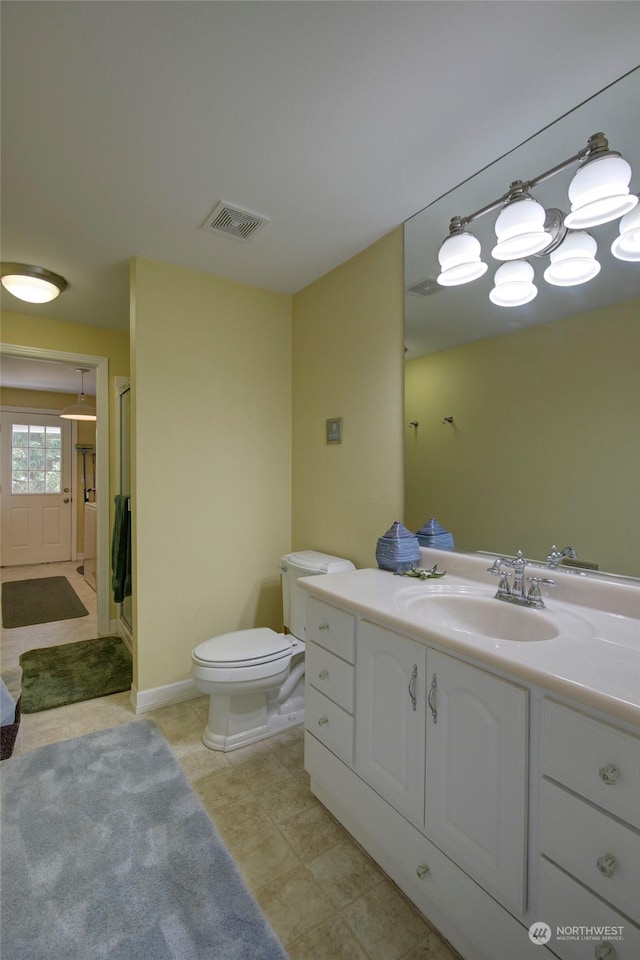 bathroom featuring vanity, toilet, and walk in shower