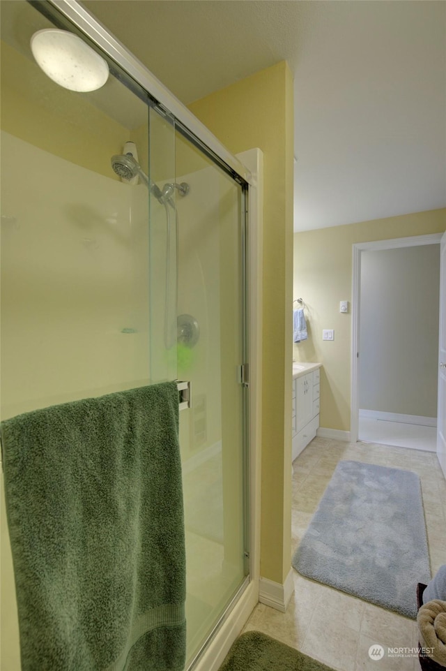 bathroom featuring an enclosed shower, tile patterned floors, and vanity