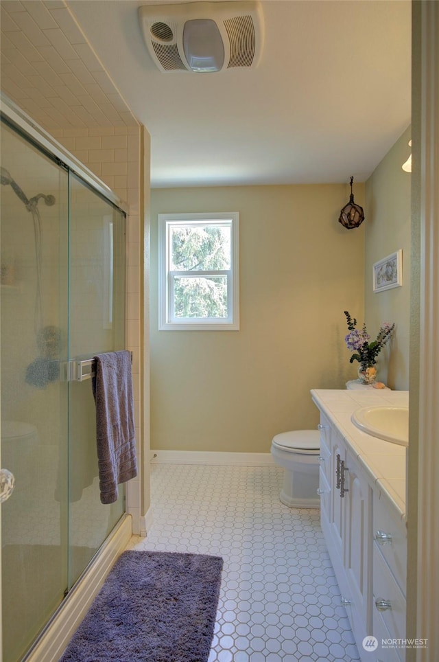 bathroom featuring an enclosed shower, vanity, and toilet