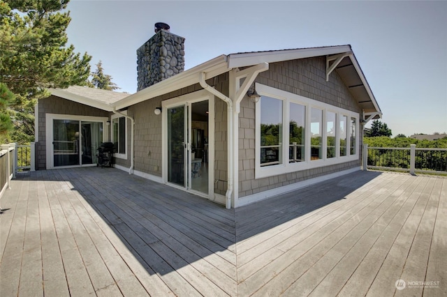 wooden terrace featuring area for grilling