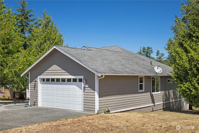 view of side of home featuring a garage