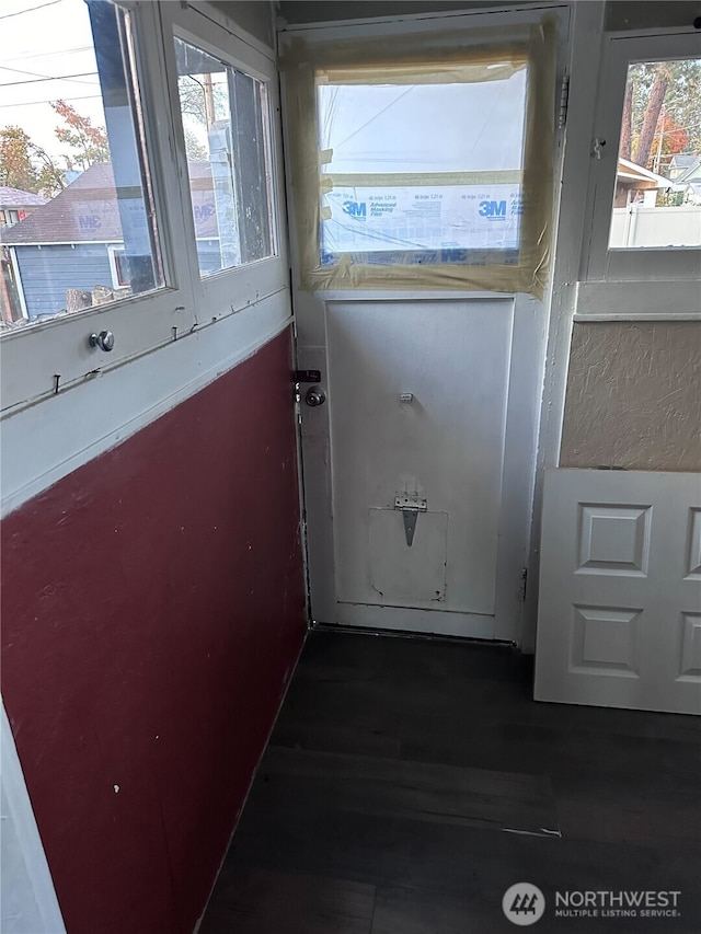 doorway with dark wood-style floors