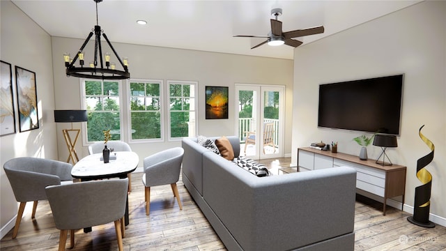 living room with ceiling fan with notable chandelier and light wood-type flooring