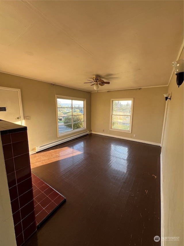 interior space featuring a baseboard heating unit, wood-type flooring, and ceiling fan