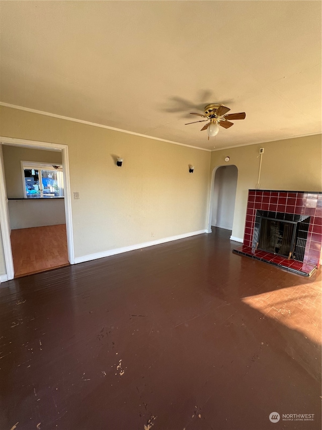 unfurnished living room featuring a tiled fireplace, ceiling fan, and hardwood / wood-style floors