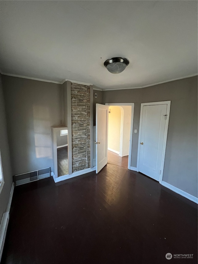 unfurnished bedroom featuring dark hardwood / wood-style flooring