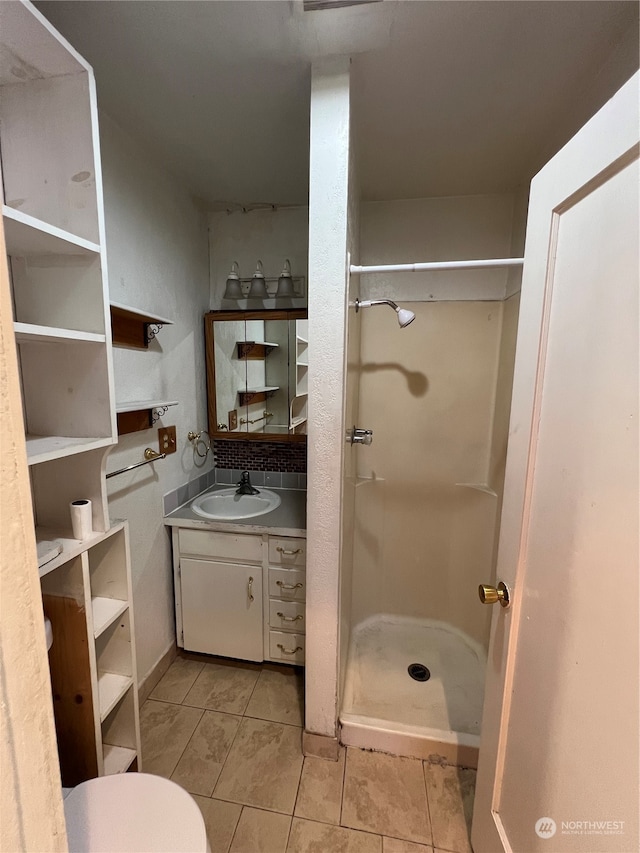 bathroom with vanity, tile patterned flooring, and walk in shower