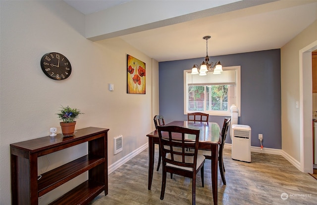 dining space featuring a notable chandelier and hardwood / wood-style floors