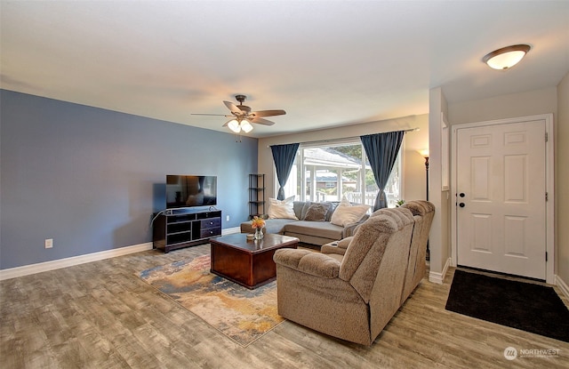 living room featuring ceiling fan and wood-type flooring