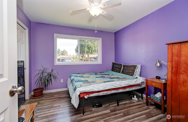 bedroom featuring ceiling fan and dark wood-type flooring