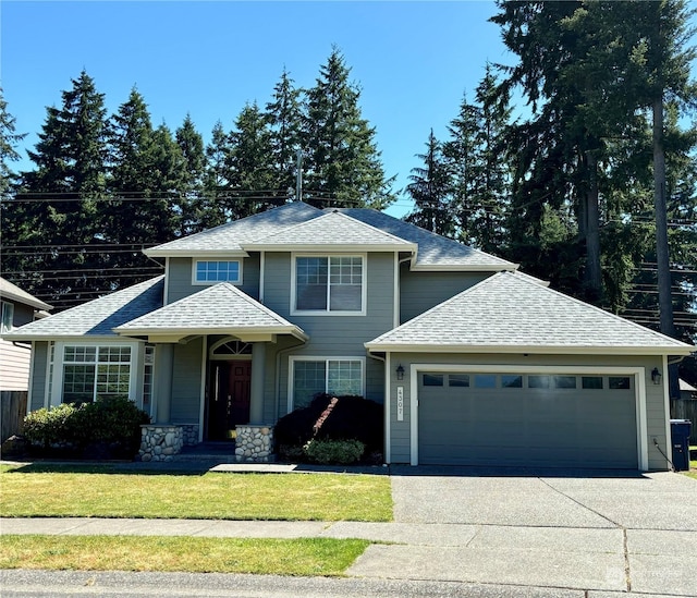 view of front of property with a garage and a front yard