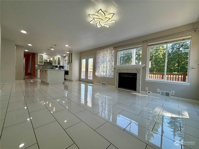 unfurnished living room with light tile patterned floors and a fireplace