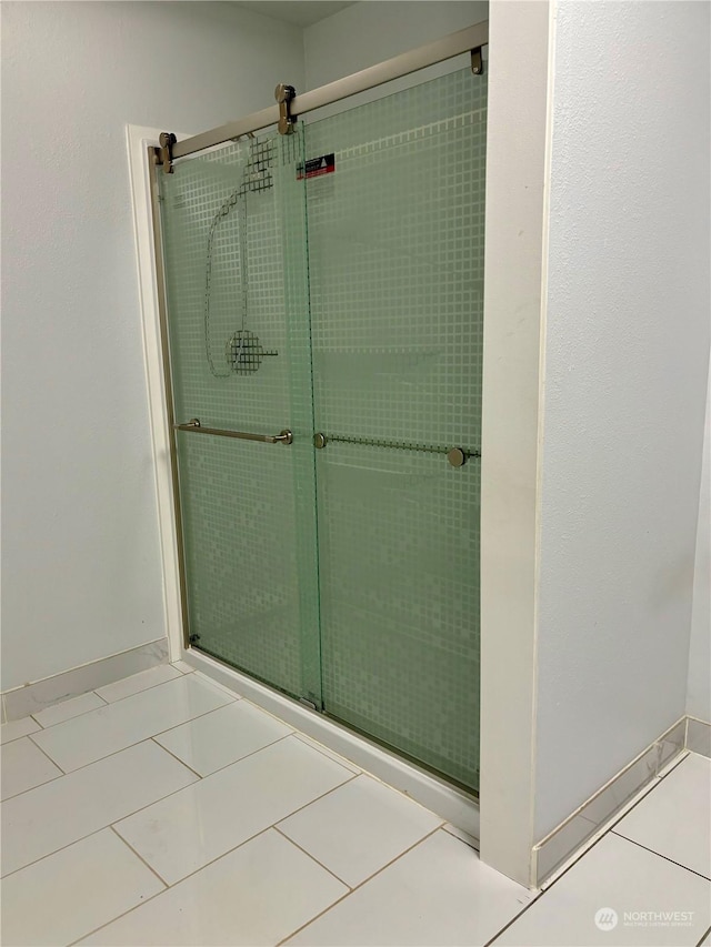 bathroom featuring walk in shower and tile patterned floors