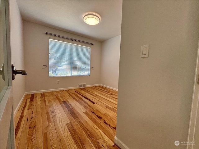 spare room featuring light wood-type flooring