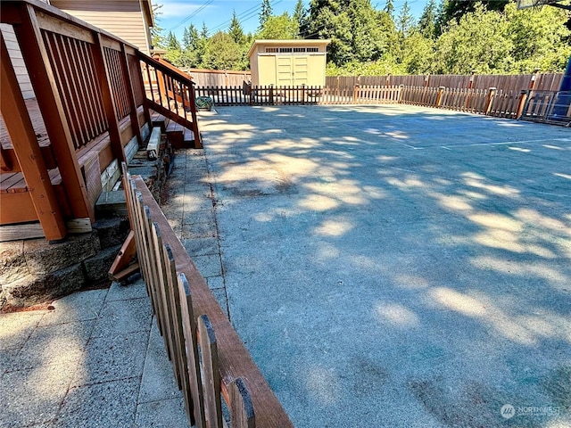 view of swimming pool featuring a storage unit and a patio area