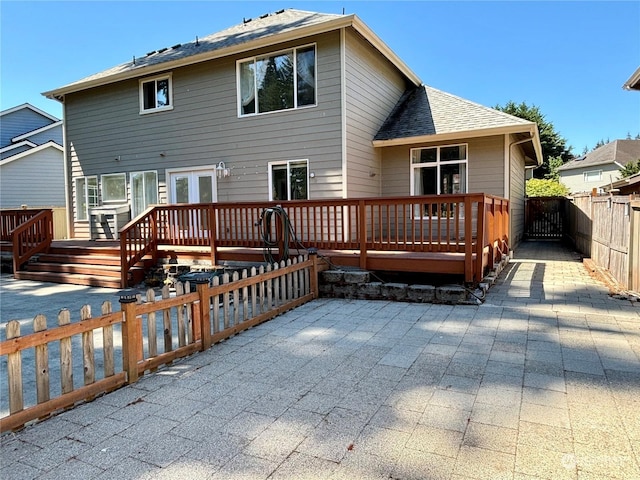 back of house featuring a deck and a patio area