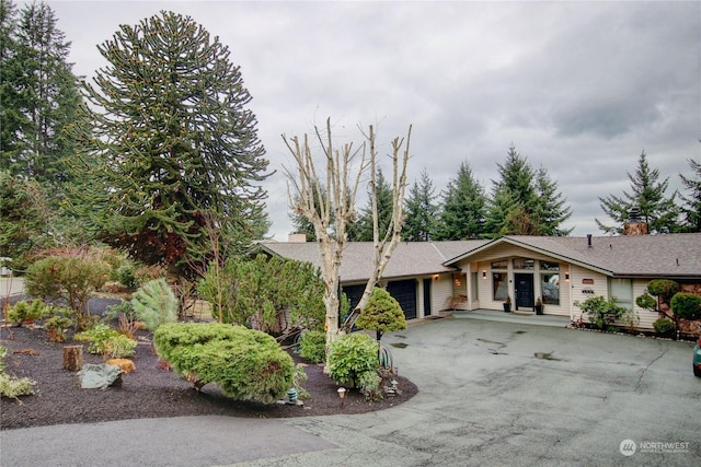 3917 Mallard Point Dr, Anacortes, WA 98221 - ranch-style home with a chimney, an attached garage, and driveway