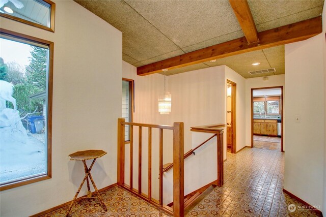 3917 Mallard Point Dr, Anacortes, WA 98221 - corridor featuring visible vents, an upstairs landing, beam ceiling, baseboards, and a chandelier