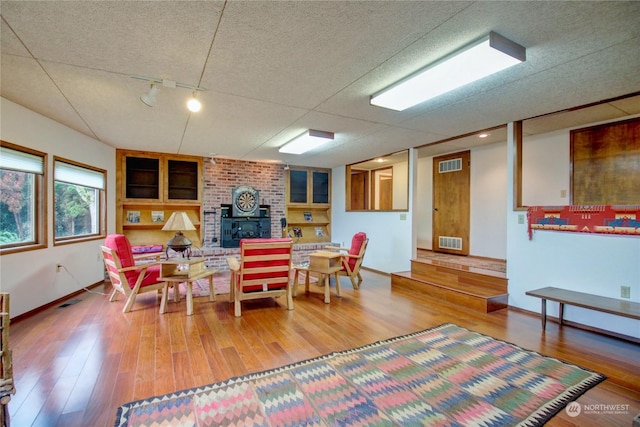 3917 Mallard Point Dr, Anacortes, WA 98221 - dining room with a fireplace, wood finished floors, visible vents, and baseboards